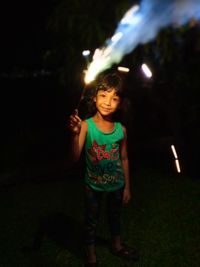 Full length of girl standing on field at night