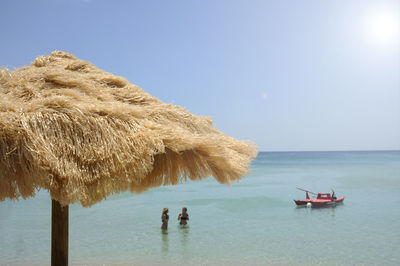 Scenic view of sea against clear sky during sunny day