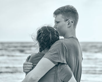 Side view of father and son at beach