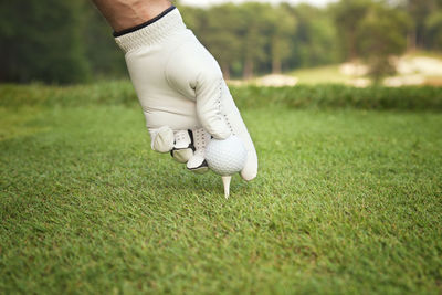 Low section of woman playing golf