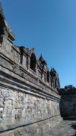 Low angle view of historical building against clear blue sky