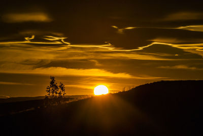 Scenic view of silhouette land against sky during sunset