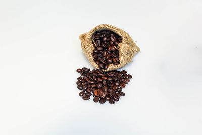 High angle view of coffee beans against white background