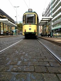 Train on street in city against sky