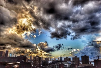 Cityscape against cloudy sky