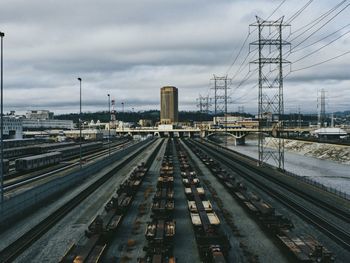 Railroad tracks in city against sky