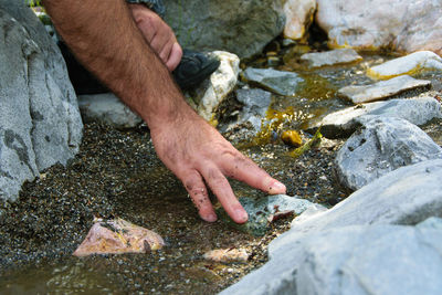 High angle view of hands on rocks