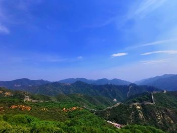 Scenic view of mountains against blue sky