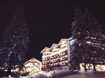 Low angle view of illuminated buildings in city at night