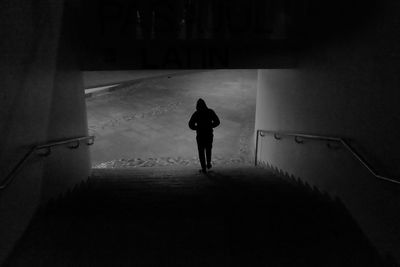 Silhouette walking on staircase