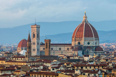 View of buildings in city against sky