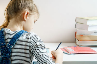 Boy reading book at table