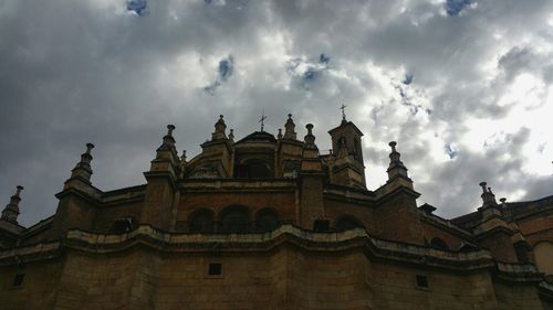 Low angle view of building against cloudy sky