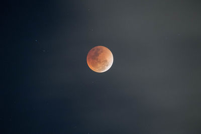 Low angle view of moon against clear sky at night