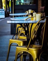 Empty chairs and table at outdoor cafe