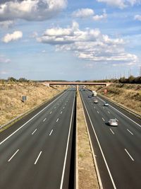 View of cars on highway against sky