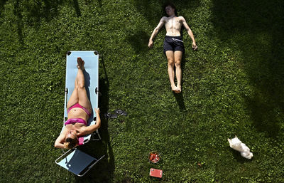 High angle view of woman and son relaxing in yard