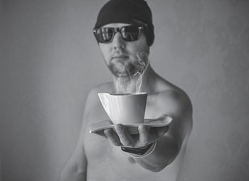 Portrait of man holding coffee cup