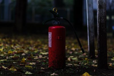 Close-up of red pipe on field