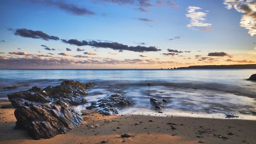 Scenic view of beach against sky during sunset