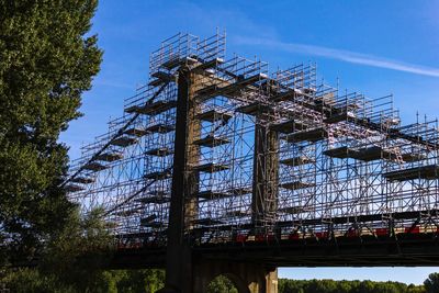 Low angle view of bridge against blue sky