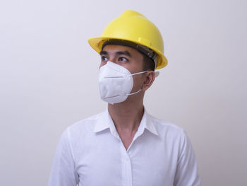 Portrait of mid adult man against white background