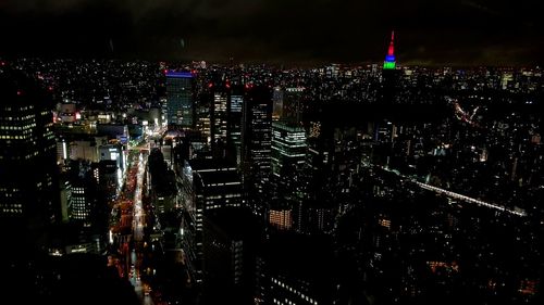 High angle view of illuminated city buildings at night