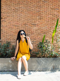 Young woman against wall