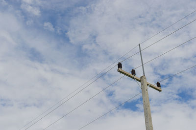 Low angle view of electricity pylon against sky