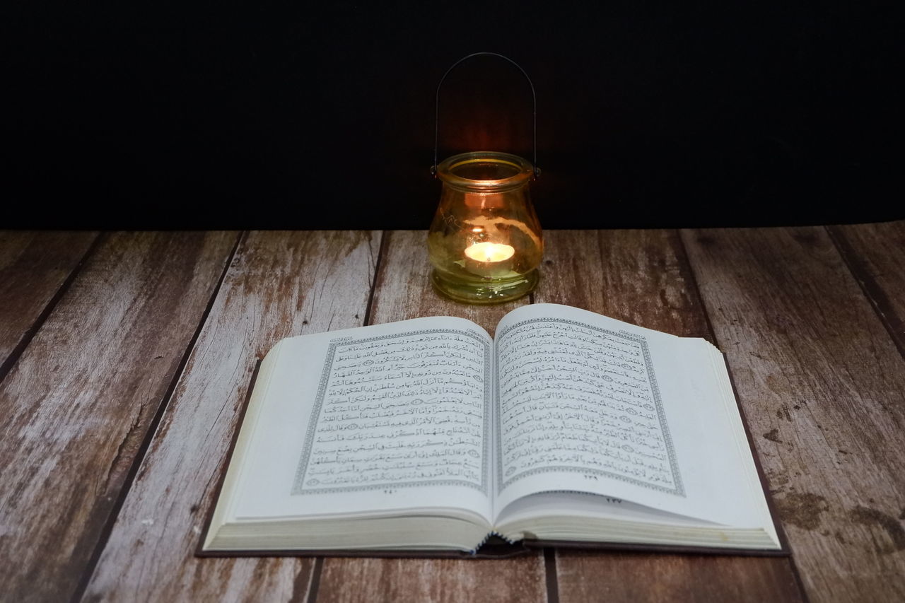 HIGH ANGLE VIEW OF ILLUMINATED LAMP ON TABLE