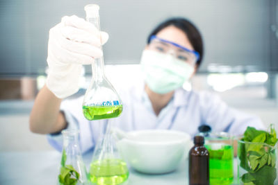 Portrait of female scientist experimenting in laboratory