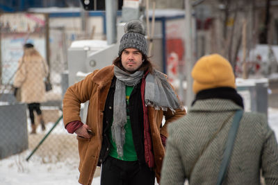 Full length of woman standing in city during winter