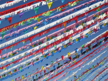 Low angle view of colorful bunting flags against sky