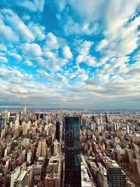 High angle view of modern buildings in city against sky