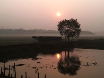 Scenic view of calm lake at sunset