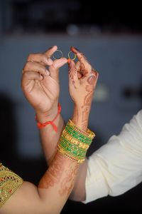 Cropped hand of woman holding flower