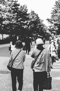 Rear view of people walking on street