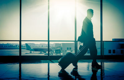 Silhouette man walking at airport