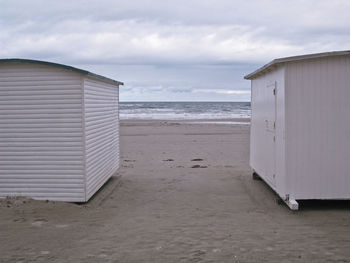 Hut on beach against sky