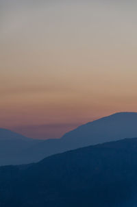 Scenic view of silhouette mountain against sky during sunset