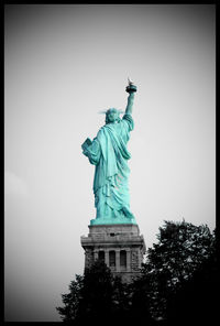 Low angle view of statue of liberty against clear sky