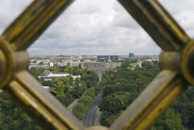 Close-up of cityscape against sky seen through window