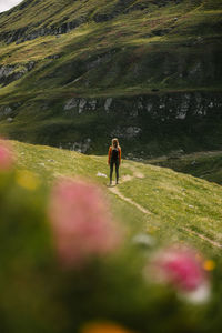 Rear view of people walking on grass