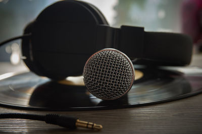 Close-up of microphone with headphones on table