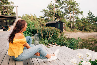 Happy young women sitting on cottage deck