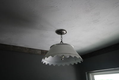 Low angle view of pendant light hanging from ceiling at home