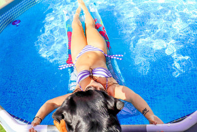 High angle view of young woman resting in swimming pool