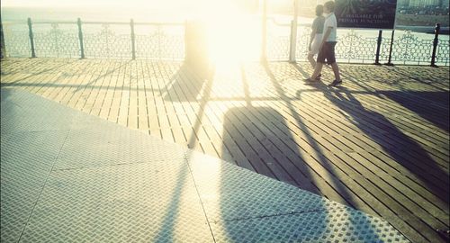 Shadow of people on road