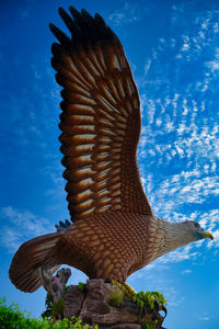 Low angle view of statue against blue sky