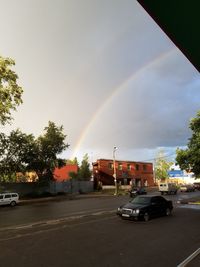 View of rainbow over city street